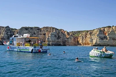 Arrive at lagos marina for a coastal boat trip with cave visits, swimming by ponta da piedade, and a floating aqua trampoline. includes drinks and shaded seating.