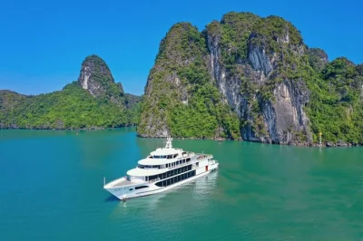 Feel the quiet magic of halong bay with a day cruise from hanoi, exploring surprise cave, kayaking near limestone cliffs, and relaxing on titop island. includes pickup.