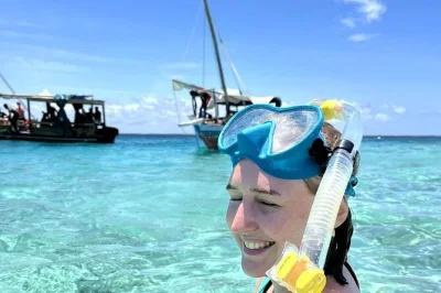 Wake up to dolphins off wasini island, snorkel kisite reefs, share swahili lunch in a local village, and visit shimoni slave caves. includes pickup and all fees.