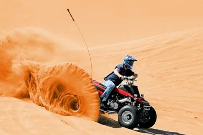 Feel the thrill of quad biking and dune bashing in dubai’s red desert, then unwind with a camel ride, arabic coffee, and live shows. includes pickup & dinner.