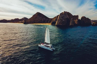 Watch humpback whales in los cabos on a luxury catamaran, cruise past the arch, enjoy an open bar, and relax with a small group—includes pickup and local crew.