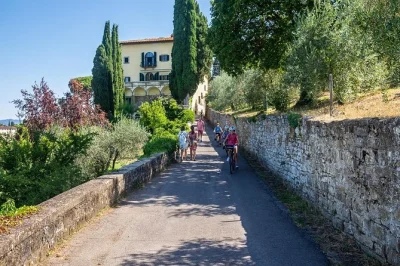Pedal from florence into the tuscan hills for wine, olive oil, and local snacks at a countryside farm. includes guide, bike, helmet, and small group experience.