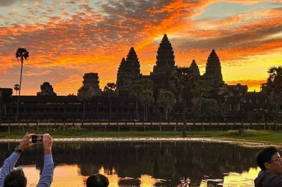 Wake up early for angkor wat sunrise, explore bayon & ta prohm with a small group, and enjoy local breakfast near the temples. includes hotel pickup & cool water.