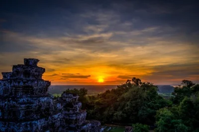 Start your angkor wat day trip from siem reap with hotel pickup, explore ancient temples like ta prohm and angkor thom, and watch sunset at phnom bakheng.
