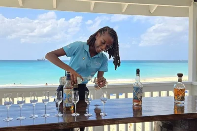 Sip barbados rum by the sea, taste four unique rums with a local guide, and relax at brighton beach club—includes welcome cocktail, chair, and umbrella.