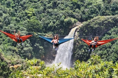 Sway above canyons in giant hammocks, zipline 1400m over colombia’s mountains, and hike to el salto del buey waterfall—private tour with pickup from medellin.