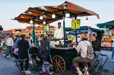 Découvrez la médina de marrakech la nuit avec une visite privée. flânez sur la place jemaa el-fna, goûtez olives et fruits secs, partagez un thé à la menthe, avec options de prise en charge fle