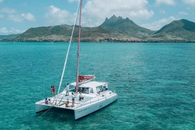 Feel the sea breeze on a mauritius catamaran cruise, snorkel near grse waterfall, enjoy a bbq lunch on board, and relax at ile aux cerfs. includes drinks & equipment.
