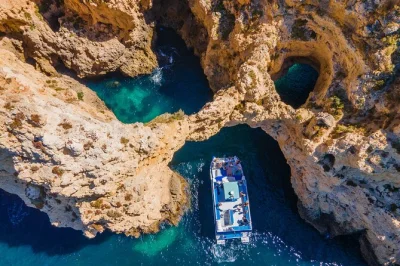 Feel the sea breeze on a lagos coast cruise to ponta da piedade, with swimming in a sheltered bay, live commentary, and local guide. includes easy boarding.