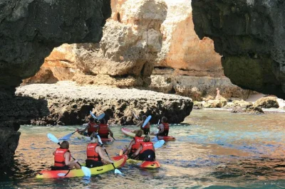 Feel the sea breeze kayaking lagos’ ponta da piedade grottos, glide past rock arches & secret beaches, guided by locals. includes water, safety boat & gear.
