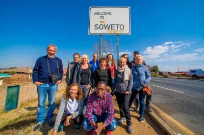 Feel soweto’s energy, walk motsoaledi settlement, taste shisa nyama lunch by the towers, visit apartheid museum. includes hotel pickup and small group guide.