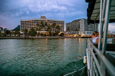 Float past cairns’ skyline & mangroves on a relaxed sunset river cruise with drinks, stories from your captain, and city lights. includes pickup & snack option.