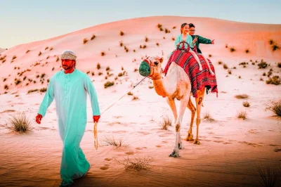 Feel the desert wake up outside abu dhabi with dune bashing, a camel ride, and sandboarding. includes hotel pickup, arabic tea and dates, and a local guide.