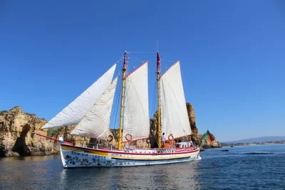 Sail from lagos to ponta da piedade, enjoy lunch on board, explore sea caves by small boat, and swim or relax in the sun. includes food, wine, and water.