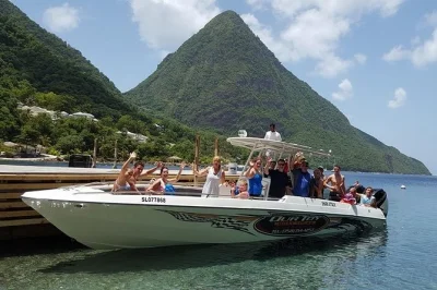 Feel the spray at toraille waterfall, soak in sulphur springs’ mud baths, and cruise by the pitons on a st lucia land and sea tour—includes local lunch and snorkeling gear.