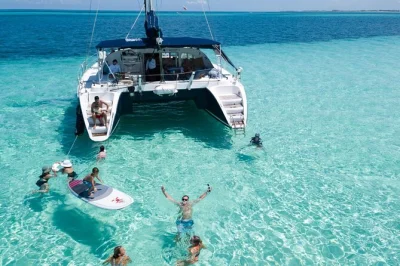 Embarque em um catamarã em puerto morelos, navegue até um banco de areia escondido, nade em águas calmas da lagoa e aproveite um almoço leve com bebidas. opção de traslado disponível.