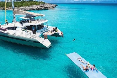 Step aboard a luxury catamaran in sint maarten for snorkeling at little bay, fresh lunch, open bar, and front-row views of planes over maho beach—includes guided gear.