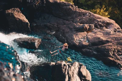Swim at cedar creek falls, relax with a chef-prepared lunch by the whitsundays, and sip cocktails at a beach bar. includes pickup, local guide, and drinks.