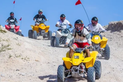 Feel the rush riding atvs across the nellis dunes near las vegas. includes hotel pickup, safety gear, and a local guide for a desert adventure close to the strip.