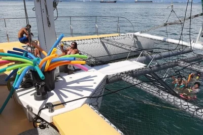 Set sail from panama city to isla taboga on a maxi catamaran, swim in a quiet bay, visit a fishing village, and enjoy lunch onboard with open bar—includes pickup.