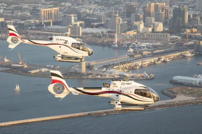 Kapstadt erleben: helikopterflug über tafelberg, clifton und die küste, danach entspannte hafenrundfahrt am v&a waterfront mit abholung & live-kommentar.
