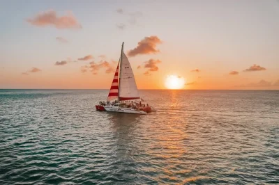 Feel aruba’s sea breeze on a sunset catamaran sail from palm beach, with local snacks, open bar, and music. includes check-in 30 minutes before departure.