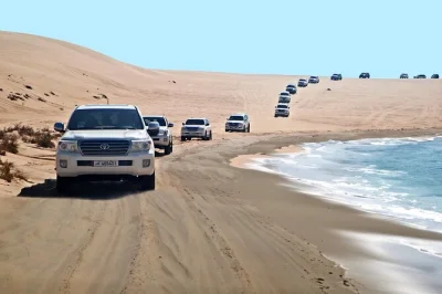 Feel the rush of a private desert safari from doha to khor al udaid, with 4x4 dune rides, local guide, and pickup included—plus a stop at the inland sea.