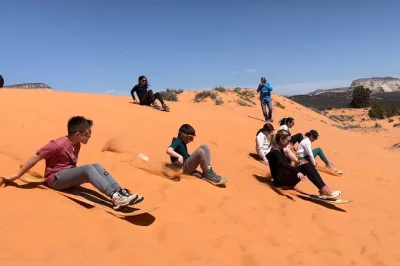 Feel the thrill of a private utv ride from kanab to peekaboo slot canyon, try sandboarding on real dunes, and explore narrow red rock passages with a local guide—includes water.