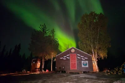 Warm up in a cozy yellowknife cabin, watch the northern lights, share local fish chowder & bannock, and enjoy small group stories. includes pickup from airport.