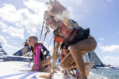 Jump, splash & laugh at southport gc aqua park on the gold coast—50 minutes of inflatable water adventure for families or friends, with life jackets included.