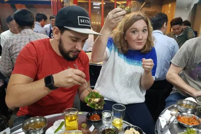 Late arrivals, smoky grills, and laughter over makgeolli—this seoul food tour dives into legendary bbq, pancake markets, and local pubs. all food and drinks included.