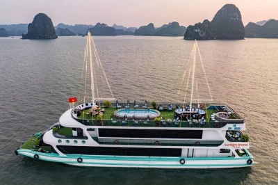 Start your halong bay day trip early for misty views, swim at titop island, kayak luon cave, and relax with a seafood buffet and sunset party. includes lunch & guide.