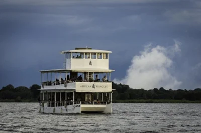 Float past elephants and hippos on a zambezi river sunset cruise near victoria falls, with drinks, snacks, and hotel pickup included. relax as the sky changes color.