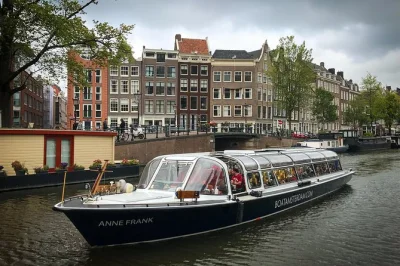 Feel the rhythm of amsterdam’s canals on a 1-hour live guided cruise with city stories, local sights like anne frank house, and drinks option. includes onboard restroom.