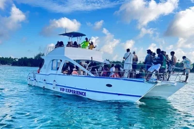 Feel the punta cana vibe on a hip-hop party boat with live dj, snorkeling at coral reefs, open bar, snacks, and a stop at a natural pool. includes pickup.