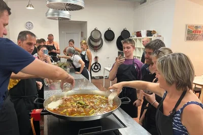 Feel the buzz of valencia as you cook real paella with locals, sip homemade sangria, and share tapas in a lively evening class—includes drinks, dinner, and all ingredients.