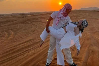 Chase the sunset on dubai’s red dunes with dune bashing, camel rides, and a bbq dinner show. includes hotel pickup, drinks, and live performances in the desert.