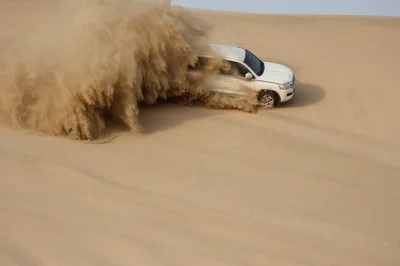 Feel the thrill of qatar’s sealine dunes with private 4x4 dune bashing, a camel ride, and a stop at the inland sea. includes pickup, drinks, and local guide.