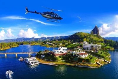 Feel the thrill of a helicopter ride over guatapé, climb the famous rock, cruise the lake by boat, and wander colorful streets—private tour with pickup included.