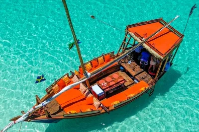 Swim with dolphins, snorkel vibrant reefs, and share a seafood bbq on mnemba island. includes dhow cruise, lunch, drinks, and all snorkeling gear—easy booking.