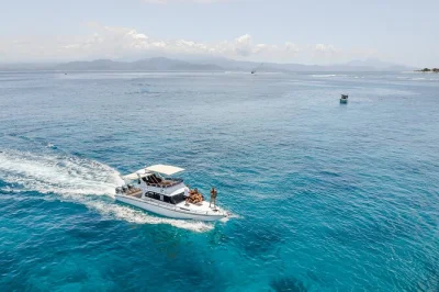 Private boat to nusa penida with snorkeling at 4 spots, swimming with manta rays, scenic lunch with mount agung views, and car tour—includes pickup & guide.