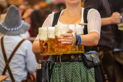 Laugh with locals, taste real bavarian beer, and get a reserved table at munich’s oktoberfest—includes city walk, lunch, and 2 liters of beer.