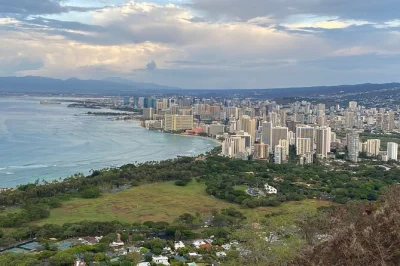 Wake up early for a diamond head sunrise hike in oahu, with entry ticket, reservation, bottled water, and flashlights included—no hassle, just pure morning views.