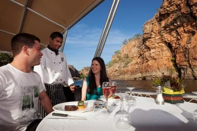 Feel the colors shift on nitmiluk gorge as you cruise at sunset, hear jawoyn stories, and share a three-course dinner cooked onboard. includes sparkling wine.