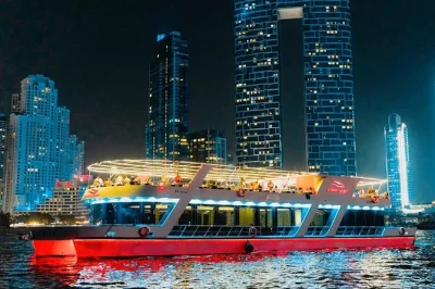 Sail dubai marina at night on a dinner cruise with live music, private seating, and open bar. includes international buffet, local guide, and flexible deck options.