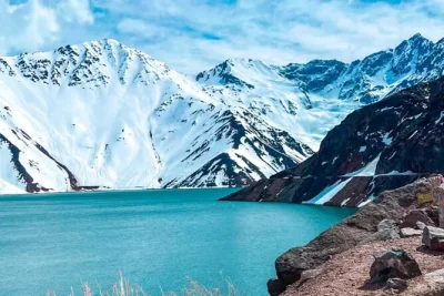 Breathe mountain air in cajon del maipo, walk el tinoco tunnel, and share a picnic with wine at el yeso dam—includes pickup from santiago and local guide.