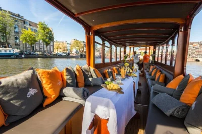 Float past amsterdam’s canal houses, skinny bridge, and anne frank house on a classic saloon boat. sip unlimited drinks, taste dutch cheese, and hear local stories live from your guide.