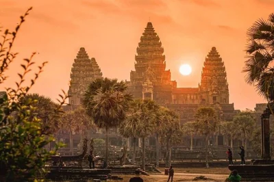 Wake up early in siem reap for a sunrise tour of angkor wat, bayon & ta prohm temples, with hotel pickup and a local guide. includes cold water & air-con vehicle.