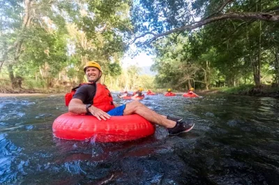 Feel the rush of rainforest river tubing near cairns, drifting through calm and rapid waters with local guides. includes hotel pickup, all gear, and snacks.