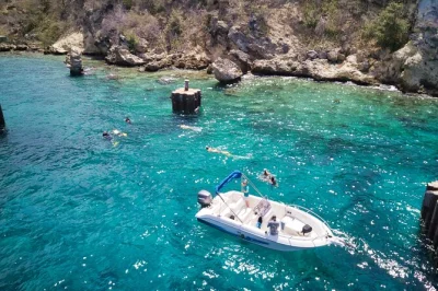 Feel the breeze on a private curacao boat trip, swim at tugboat beach, snorkel with fish, and relax at santa barbara pier. includes equipment & flexible stops.